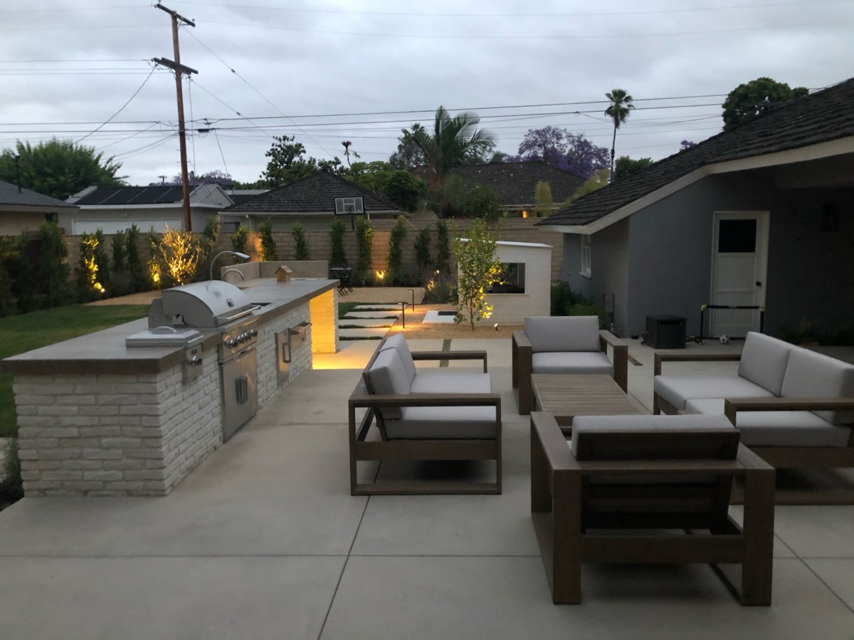 Backyard patio with an outdoor kitchen and new concrete flatwork