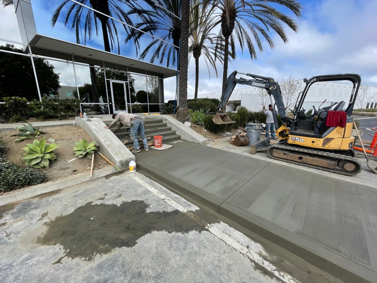 L.E.D.R. Corp crew placing a new concrete walkway at a commercial office building