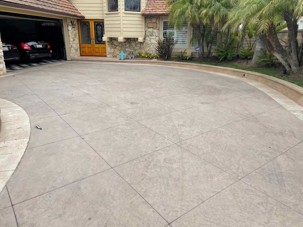 Curved concrete driveway in front of a home