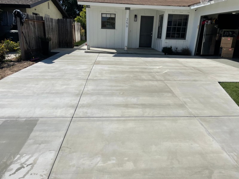 Finished broom-finish concrete slab in a backyard