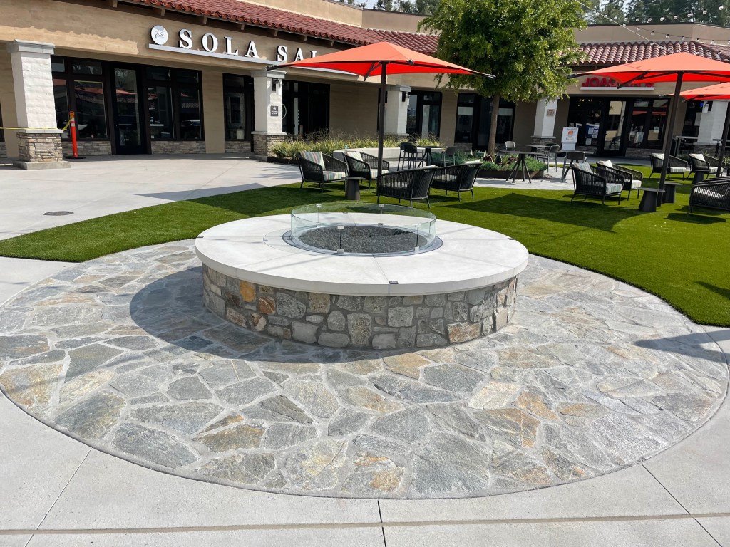 Flagstone patio around a stone fire pit at a restaurant