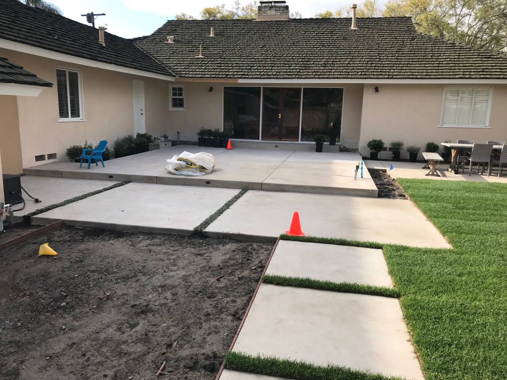 Concrete stepping pads set in a backyard lawn